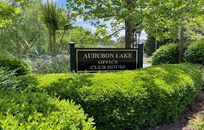 a sign for the audubon lake office club house