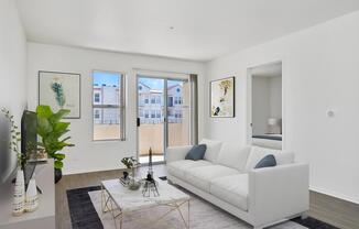 a living room filled with furniture and a large window