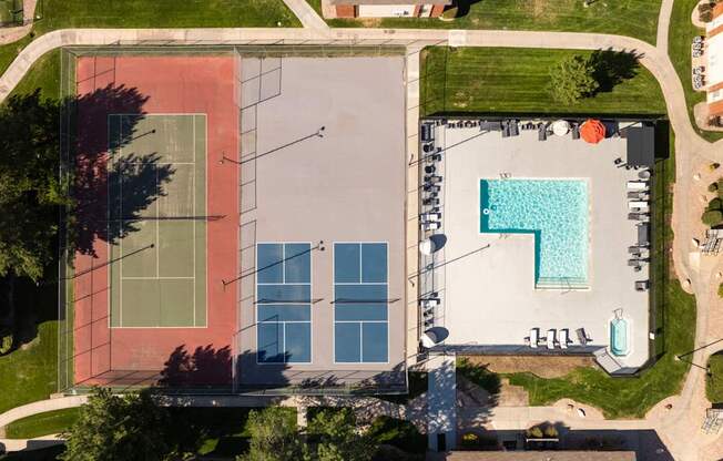 arial view of a building with a pool on the side of it
