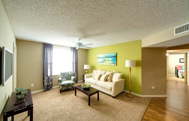 A living room with a couch, chair, and coffee table.