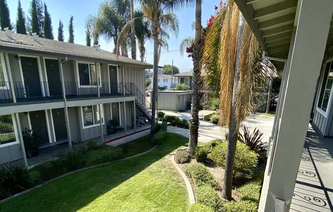 the view of the courtyard from the balcony of a condo building