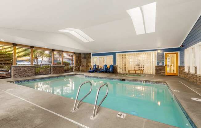 a swimming pool with chairs and a glass door