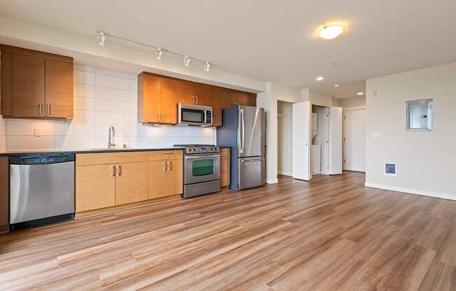 A kitchen with wooden cabinets and stainless steel appliances.