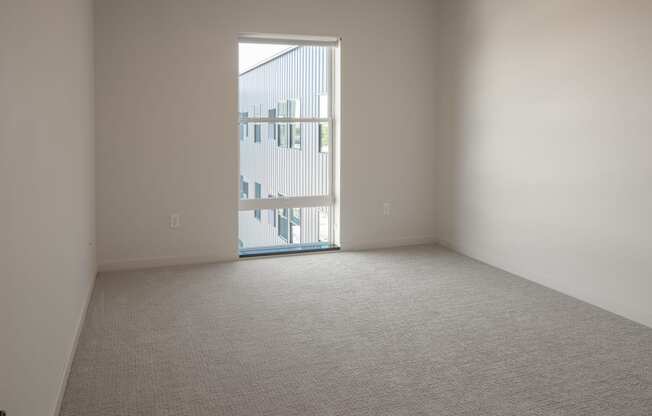 an empty room with a door to a balcony at Riverhouse Apartments, Fargo