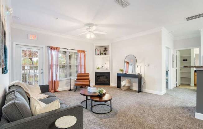 A living room with a grey couch, a coffee table, and a fireplace.
