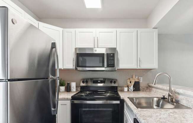 a kitchen with a stove top oven by a refrigerator