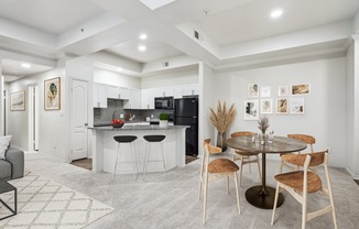 a living room with a kitchen and a dining table at La Ventura Apartments, Plano