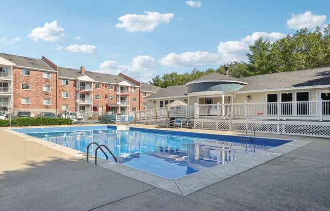 A swimming pool in front of apartment buildings.