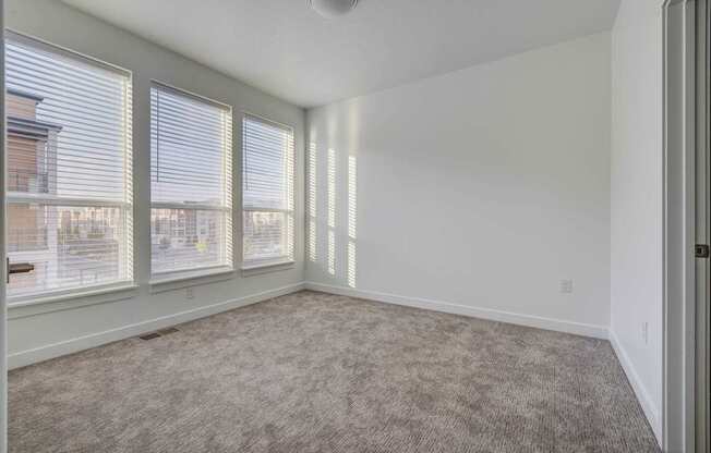 A room with a carpeted floor and a ceiling fan. at Reveal, Draper, UT