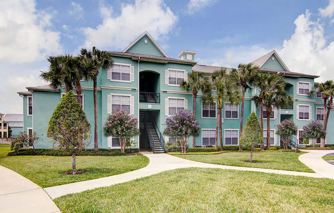 Building Exterior and Green Space at Bermuda Estates Apartments in Ormond Beach, FL