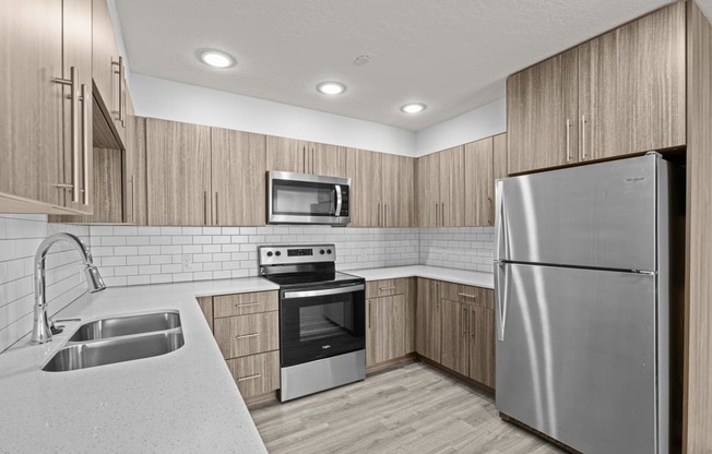 a kitchen with stainless steel appliances and wooden cabinets