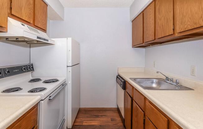 a kitchen with a stove sink and refrigerator