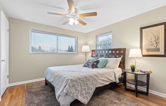 a bedroom with a bed and a ceiling fan