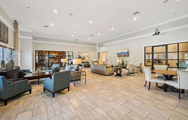 the lobby of a hotel with couches chairs and tables