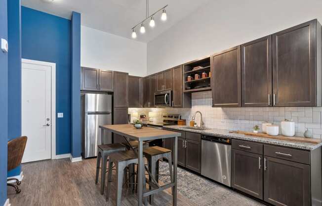 a kitchen with stainless steel appliances and a wooden table