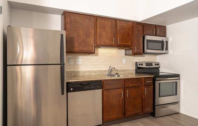 a kitchen with wooden cabinets and stainless steel appliances