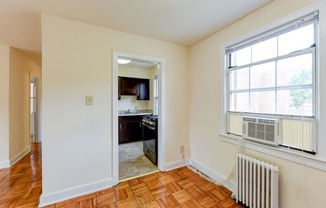 Dining area with view of kitchen with window and energy efficient appliances at colonnade apartments in washington dc