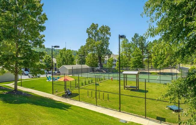 a park with a playground and a tennis court