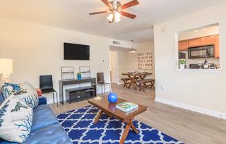 a living room filled with furniture and a flat screen tv