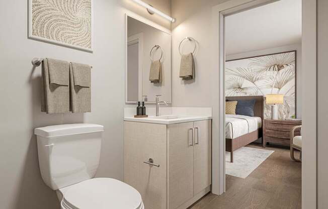 A bathroom with a toilet, sink, and mirror.