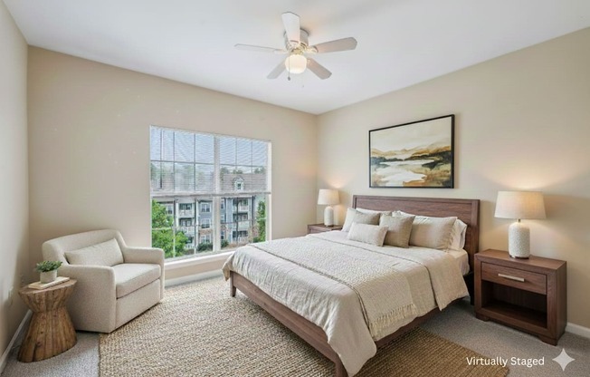 A bedroom with a large bed, a chair, and a painting on the wall.