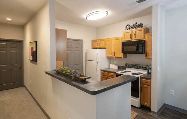 a kitchen with white appliances and wood cabinets and a counter top