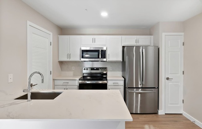 New construction with luxury plank flooring, quartz and premium finishes in select units - Evergreen Lenox Park