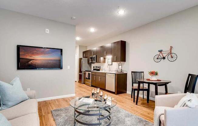 a living room and kitchen with a couch and a table. Circle Pines, MN Lexington Lofts