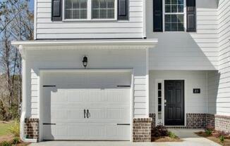 Harris Trail Luxury Townhomes for rent Richmond Hill, GA photo of white townhome with garage