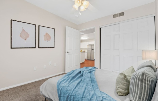 a bedroom with a bed and a ceiling fan