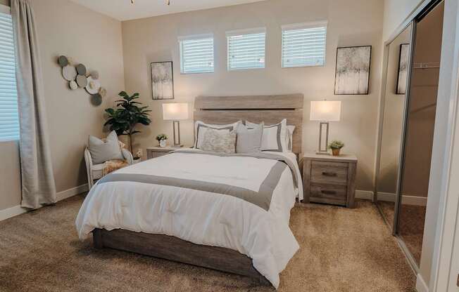 Primary bedroom with cozy bedroom furniture and windows.