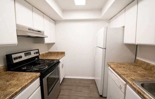 a kitchen with white cabinets and stainless steel appliances and granite counter tops