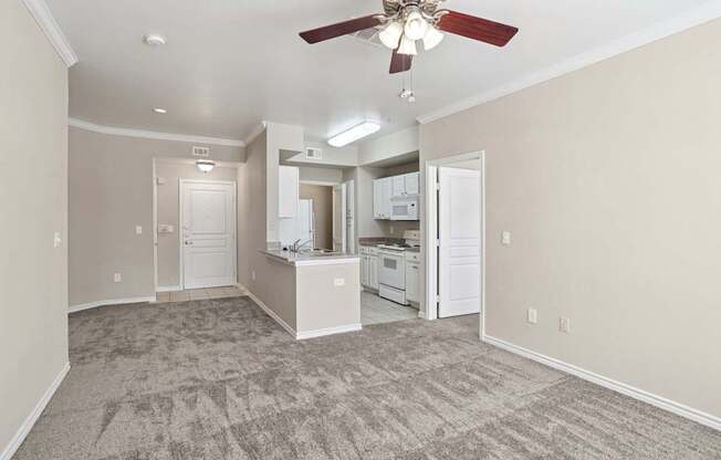 Edinburgh living room with carpet and a ceiling fan at Encore at Buckingham Apartments in Richardson, TX