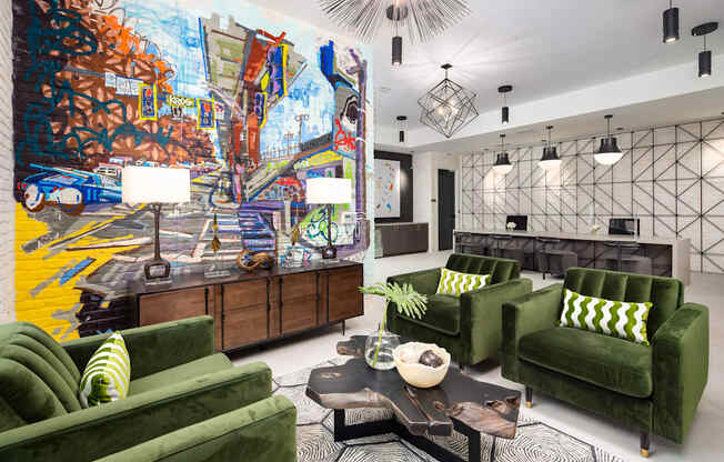 a living room with green couches and a colorful mural on the wall