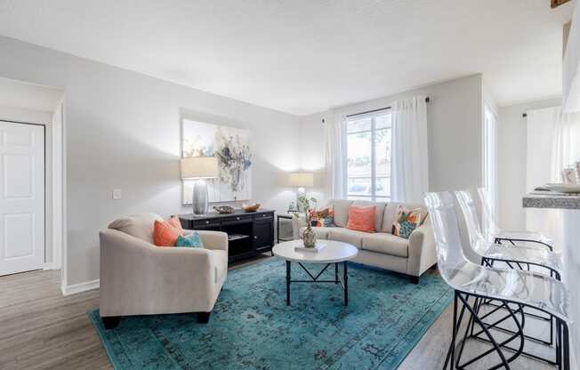 a living room with white walls and a turquoise rug at Heritage Bay, Florida, 34957