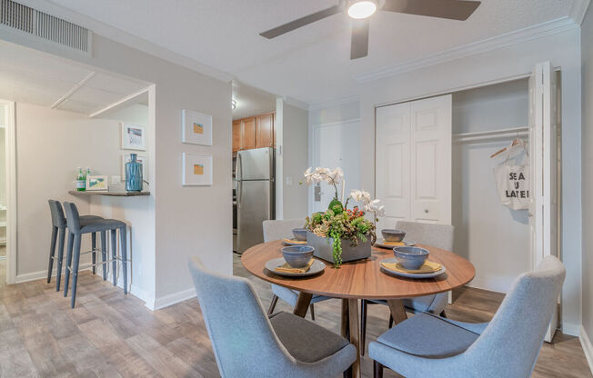 a dining room and kitchen with a table and chairs at City View Apartments at Warner Center, Woodland Hills, 91367