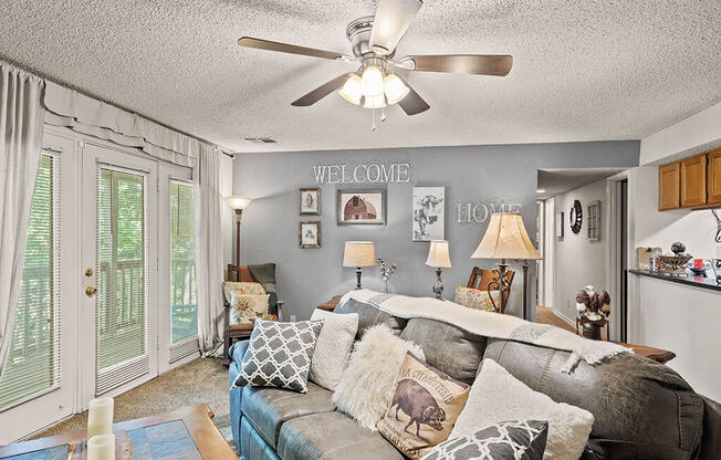 apartment living room with a couch and a ceiling fan