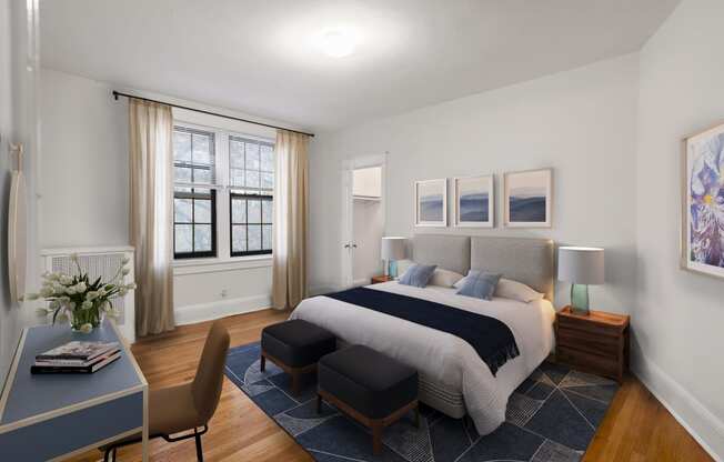 a bedroom with a bed and a desk and a window