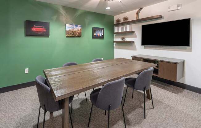 a conference room with a long table and a television at The Hendrix, Atlanta, Georgia