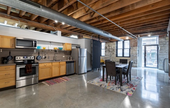 a kitchen with stainless steel appliances and a dining table