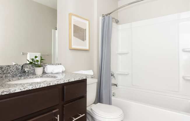 a bathroom with a toilet sink and bathtub in a 555 waverly unit