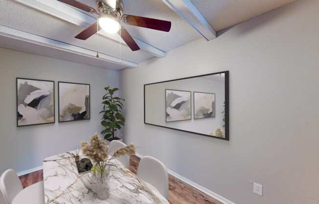 our dining room with a table and chairs and a ceiling fan