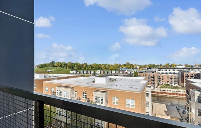 the view of the city from the balcony of an apartment building