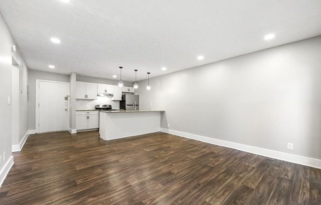 Living room with updated flooring and private patio at Balfour Chastain, Sandy Springs, GA