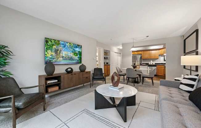 A modern living room with a flat screen TV mounted on the wall.