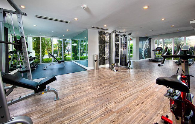 a gym with floor to ceiling glass windows and a wood floor at Saba Pompano Beach, Pompano Beach, 33062