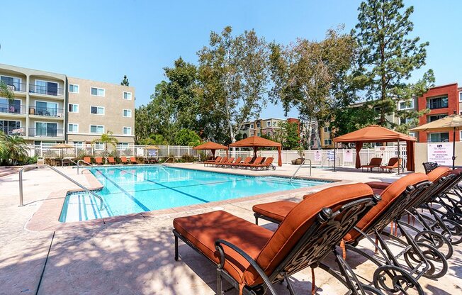 Woodland Hills CA Luxury Apartments The Reserve at Warner Center Resort Style Pool with Shaded Cabanas and Lounge Chairs
