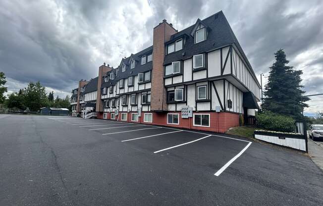 a large white and red building with a cloudy sky in the background at Kings Court, Anchorage, AK 99501 ? 