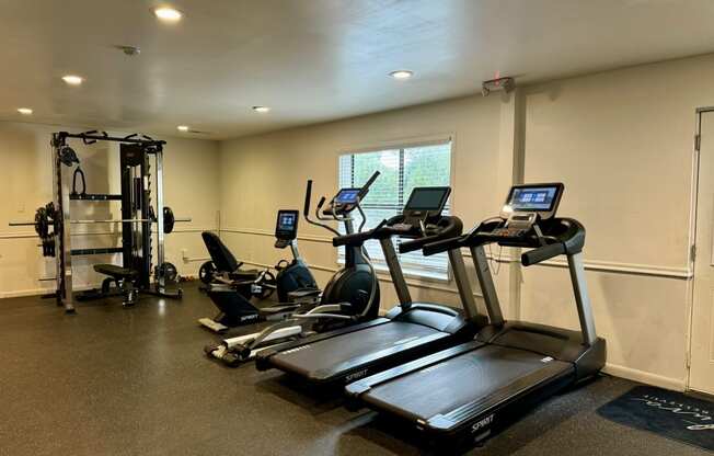 a gym with treadmills and other exercise equipment