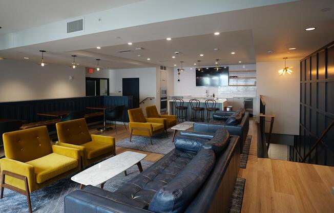 a lounge area with couches and chairs and a bar in a lobby at The Commonwealth Building, Pittsburgh, 15222